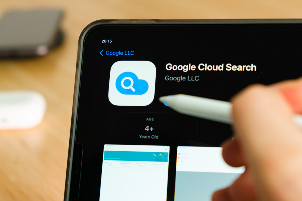google cloud search logo shown by apple pencil on the iPad Pro tablet screen. Man using application on the tablet. December 2020, San Francisco, USA.